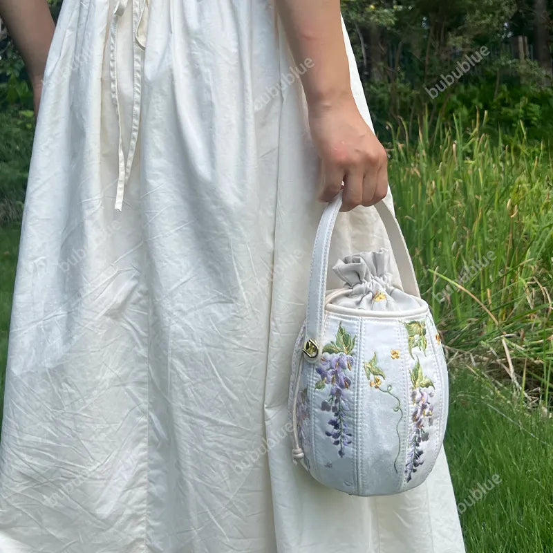 Wisteria Embroidered Drawstring Bucket Bag in Cream Satin