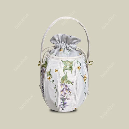 Wisteria Embroidered Drawstring Bucket Bag in Cream Satin